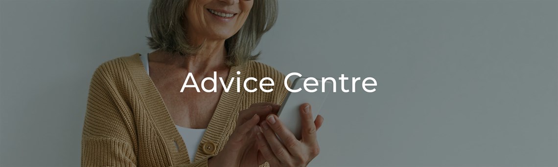 Smiling woman in cardigan looking at her phone