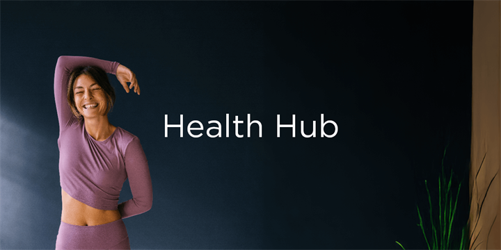 Smiling woman in cardigan looking at her phone