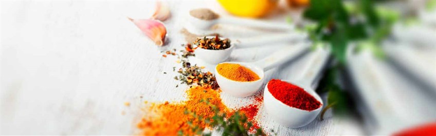 Ayurvedic spices in small bowls on table
