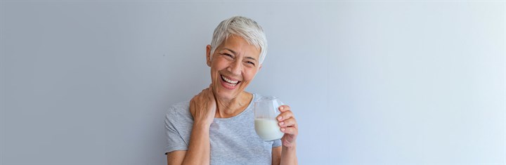 Older woman with a glass of milk