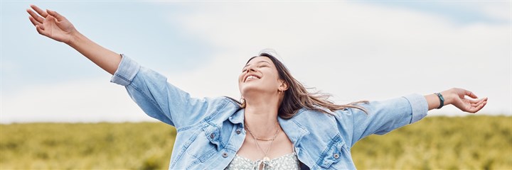 Women looking happy with her arms in the air