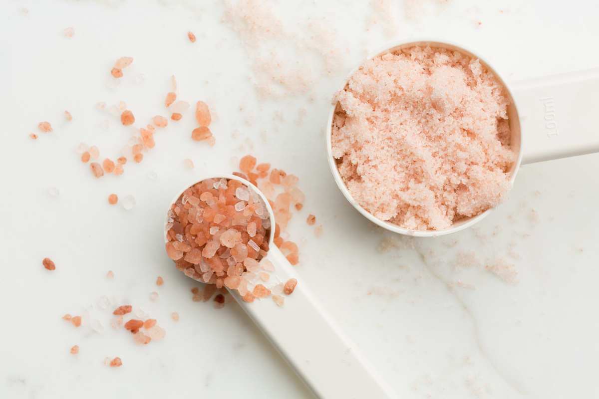 Pink Himalayan salt in measuring spoons