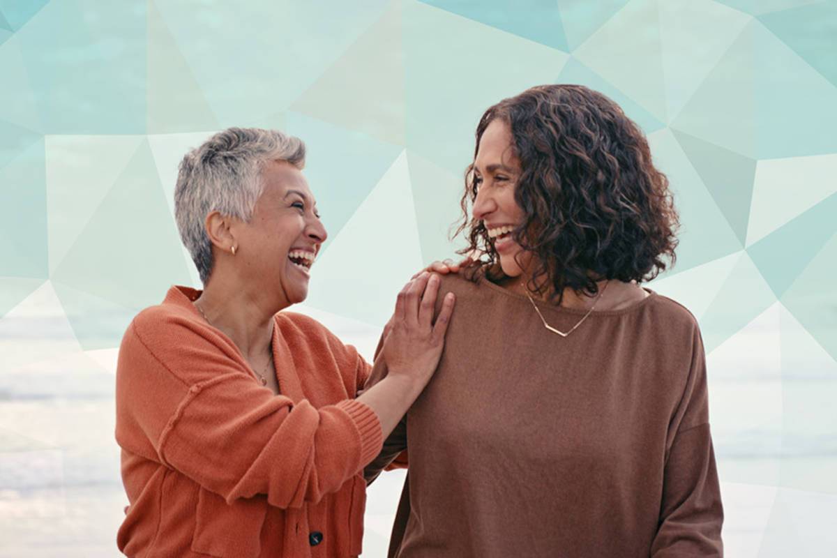 Older and younger woman smiling together