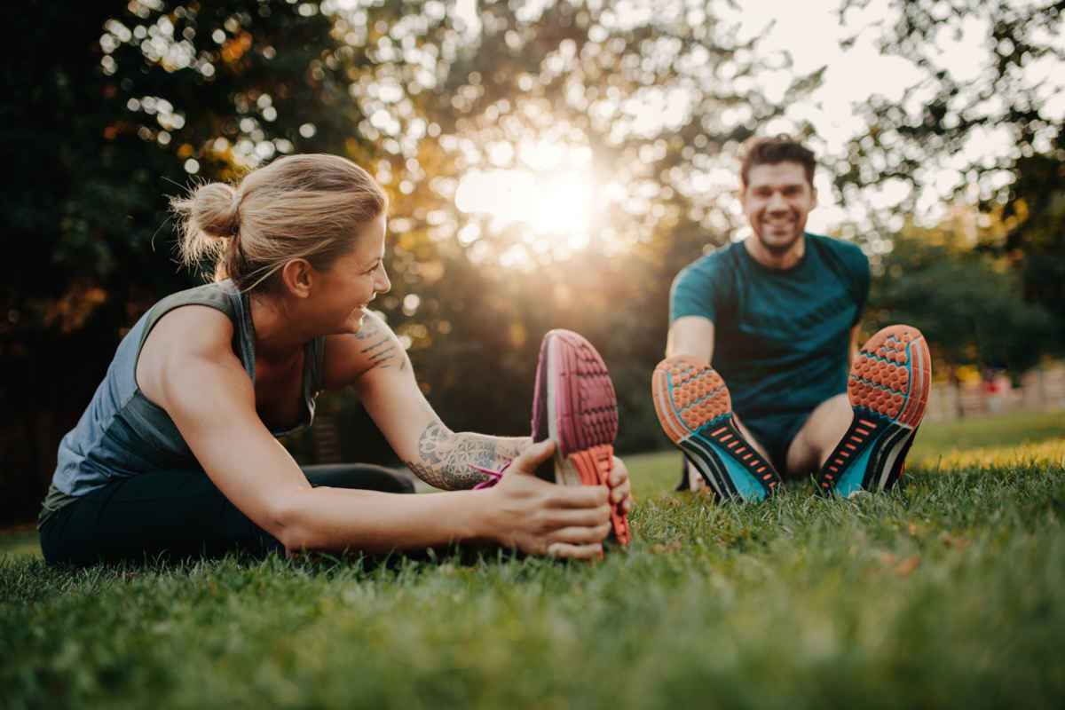 Man and woman stretching in the park